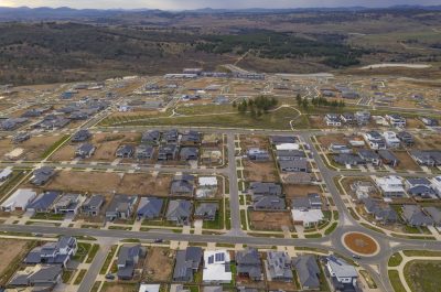 Aerial view of streets, houses and housing development in the newly established suburb of Denman Prospect in Canberra, Australia