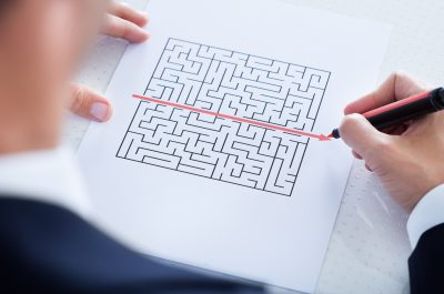 Close-up Of Hand Solving Puzzle