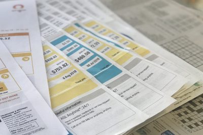 Mulitple bills with newspaper background