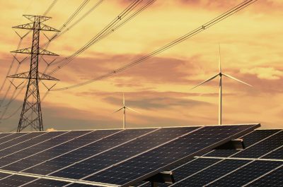 electricity power in nature. clean energy concept. solar panel with turbine and tower hight voltage