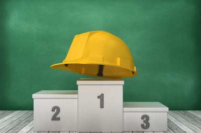 Podium with Construction Helmet on Chalkboard Background – 3D Rendering