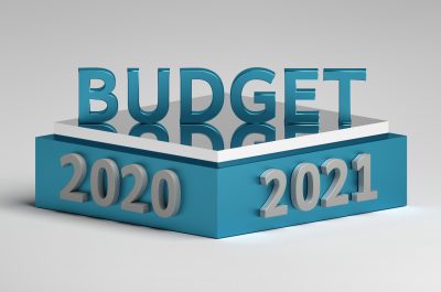 Word Budget standing on a podium pedestal with 2020 and 2021 year numbers