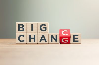 “Big Change and Big Chance” Written Red Wood Blocks Sitting on Wood Surface in Front a Defocused Background