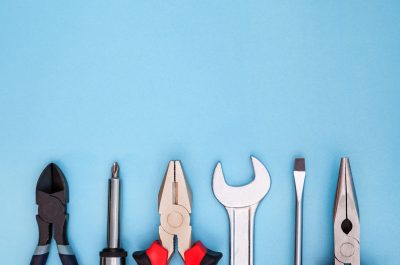 Various tools worker, hammer, wrench, screwdriver, pliers on a blue background, top view with free space