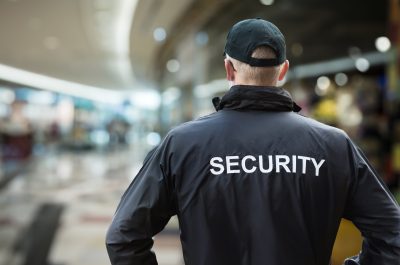 Security Man Looking At Moscow Kremlin And St Basil’s Cathedral