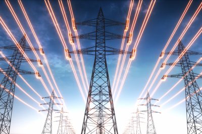 Electricity transmission towers with red glowing wires