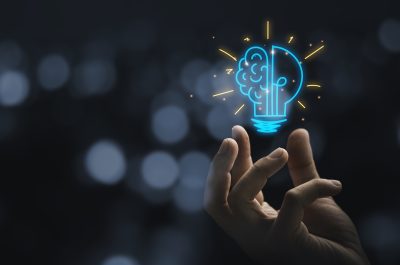 Hand holding drawing virtual lightbulb with brain on bokeh background for creative and smart thinking idea concep