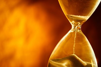 Sand passing through the bulbs of an hourglass