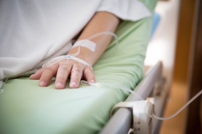 Focus patient’s hand has get the saline solution syringe on it. Illness and treatment. Health insurance plan.