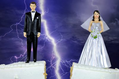 bride and groom on split wedding cake