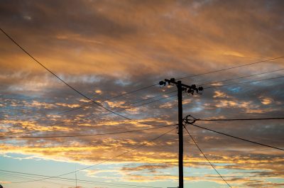 Silhouette,Of,Power,Pole,And,Power,Lines,In,Lightning,Ridge
